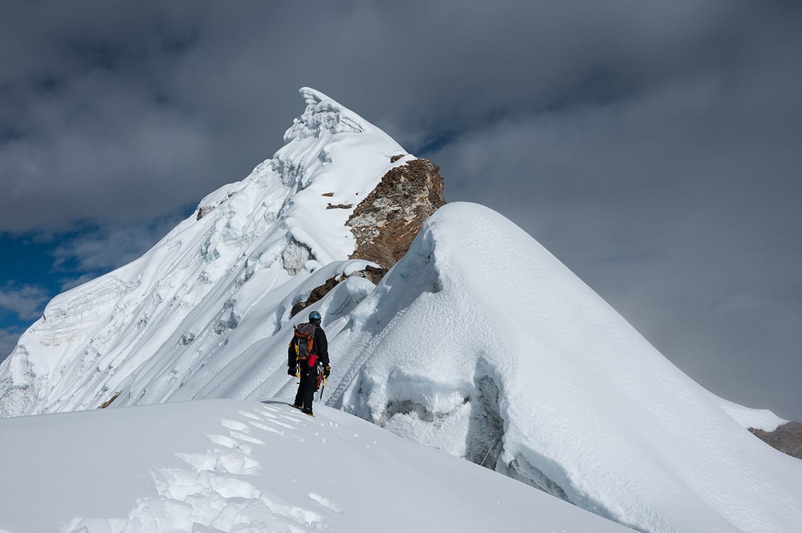 Climber on Lobuche East: Surrounded by Snow-Capped Mountains